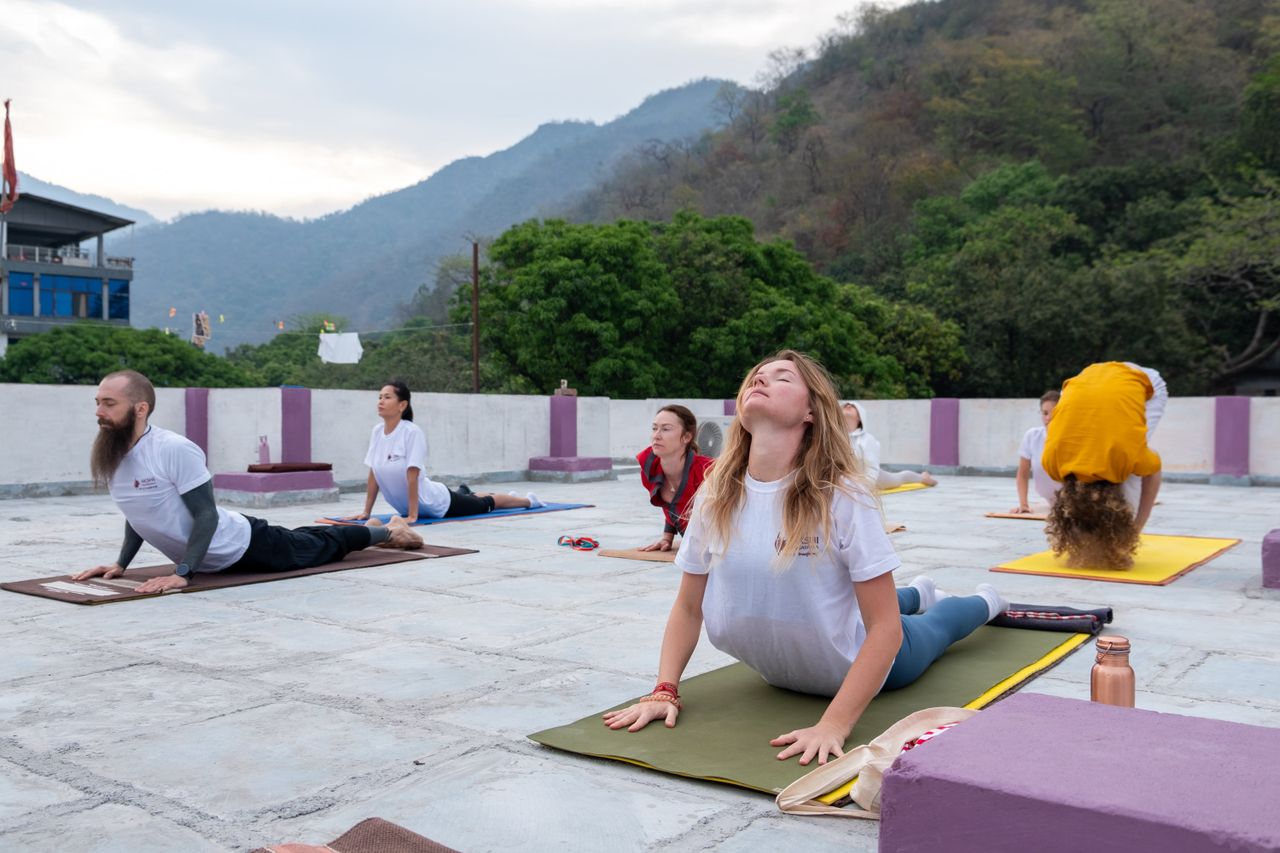 A group practicing yoga outdoors on a mountain terrace, fostering well-being and mindfulness.